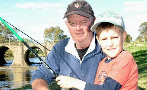 Five-year-old Ryan Clark and his dad Ian Clark wait for a nibble at the Condamine River on Saturday. Five-year-old Ryan Clark and his dad Ian Clark wait for a nibble at the Condamine River on Saturday.